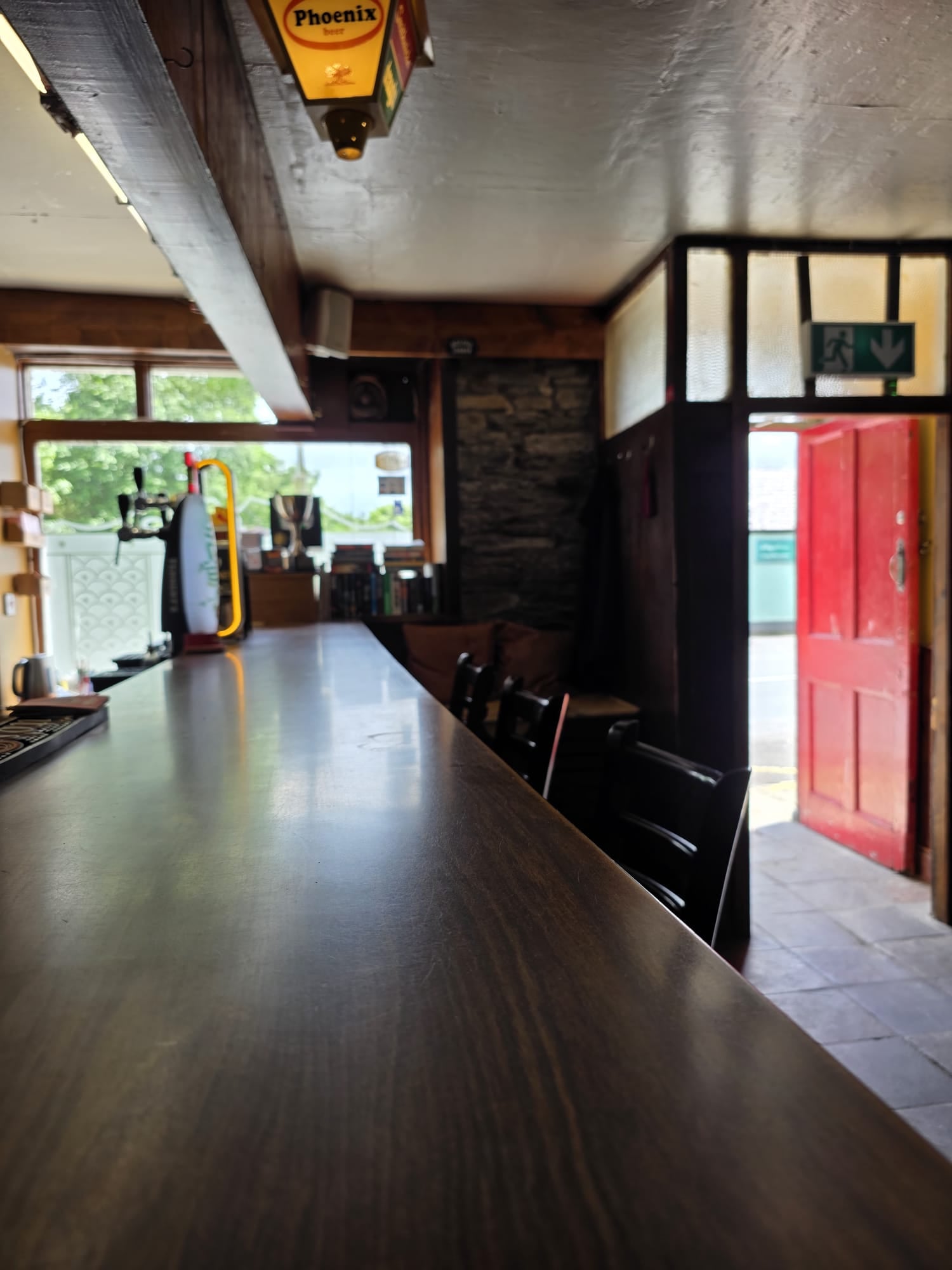 Looking down the polished bar towards the red front door at McGowan's