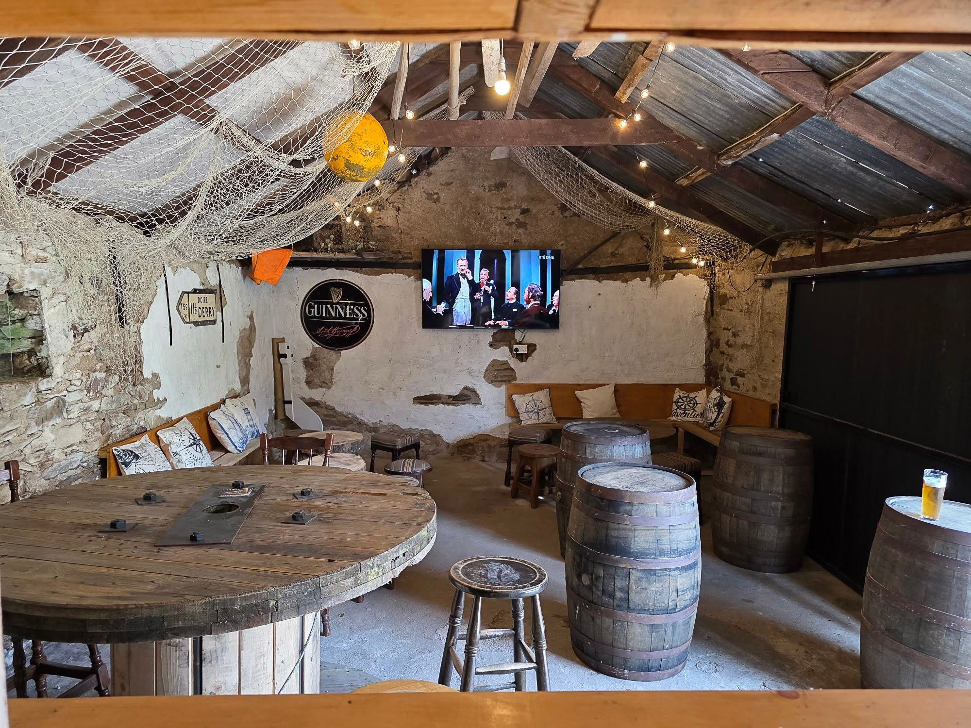The indoor beer garden with barrels and string lights
